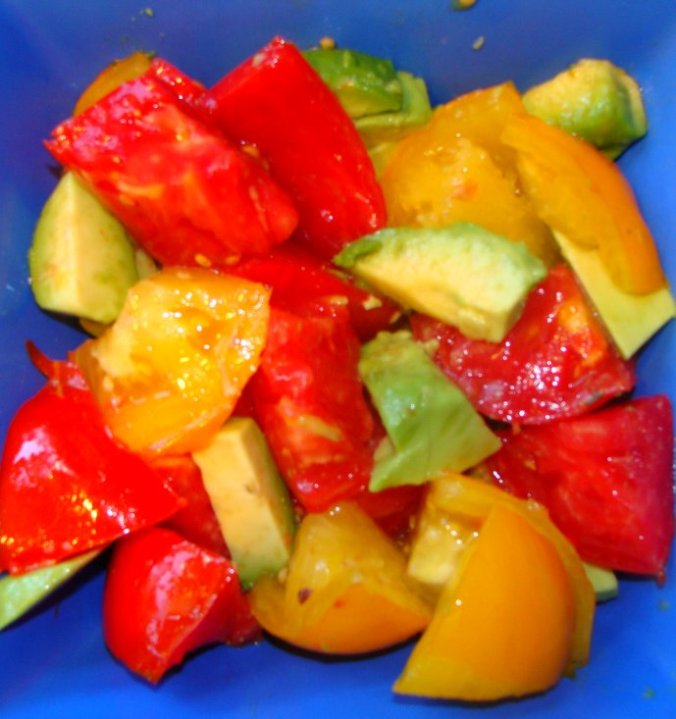 Yellow and red tomatoes with avocado.